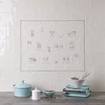 Wall of tiles with kitchenware and utensil charcoal illustrations for a range cooker tile panel styled with cottage kitchen decor