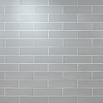 Wall of skinny pale green matt metro tiles with silver grey grout laid in a brick bond tile pattern
