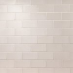 Wall of parchment white matt metro tiles with jasmine grout laid in a brick bond tile pattern