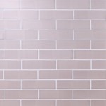 Wall of skinny metro blush pink matt tiles with white grout laid in a brick bond tile pattern