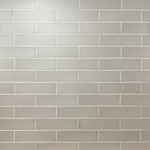 Wall of sage green skinny metro matt tiles with jasmine grout laid in a brick bond tile pattern