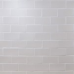 Wall of sky white metro matt tiles with white grout laid in a brick pond tile pattern