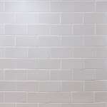 Wall of sky white metro matt tiles with white grout laid in a brick pond tile pattern