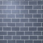 Wall of matt slate blue brick metro tiles laid in a brick bond tile tile pattern