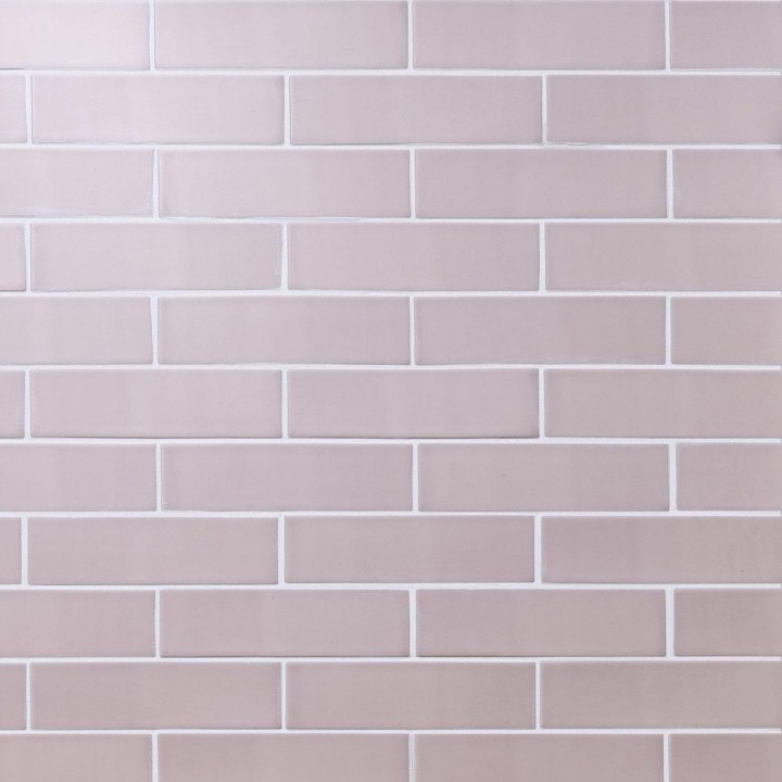Wall of skinny metro blush pink matt tiles with white grout laid in a brick bond tile pattern
