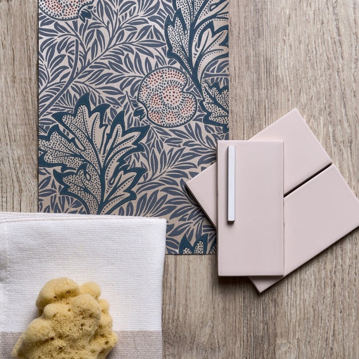 Flatlay of morris and co arts and crafts wallpaper with blush pink metro tiles and weathered oak backdrop