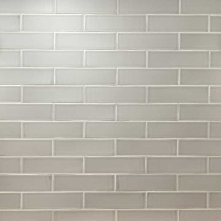 Wall of sage green skinny metro matt tiles with jasmine grout laid in a brick bond tile pattern