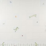 Wall of ivory tiles with hand painted sitting and leaping frogs, pond grasses and insects