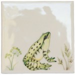 Cut out of a green sitting frog ivory tile with grasses