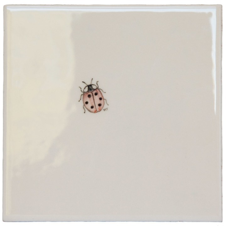 Cut out of a ladybird ivory tile