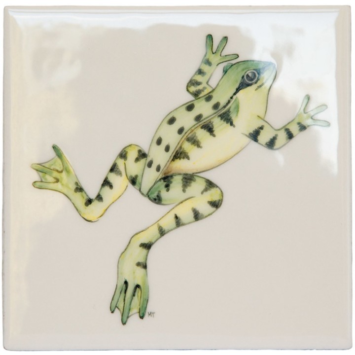 Cut out of a green leaping frog ivory tile