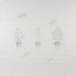 Wall of off white metro and square tiles with herb garden motifs from lavender to parsley