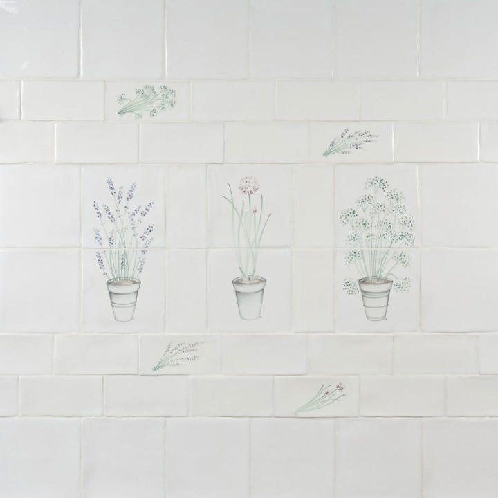 Wall of off white metro and square tiles with herb garden motifs from lavender to parsley