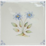 Cut out of an ivory square tile with hand painted delft corners and forget-me-not blue flower