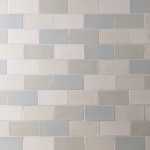 Wall of a mixture of medium brick metro tiles in blues, greys and off-whites