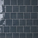 Wall of square dark navy handmade wall tiles finished with White grout, ideal for a bathroom or kitchen
