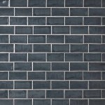 Wall of metro dark grey handmade wall tiles finished with Silver Grey grout, ideal for a bathroom or kitchen