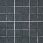 Wall of square dark grey handmade wall tiles finished with White grout, ideal for a bathroom or kitchen