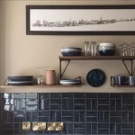 Dark navy blue small brick shaped wall tiles in a basket weave pattern on a kitchen wall
