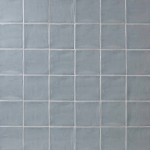 Wall of square medium grey handmade wall tiles finished with White grout, ideal for a bathroom or kitchen