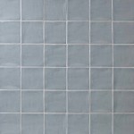 Wall of square medium grey handmade wall tiles finished with White grout, ideal for a bathroom or kitchen