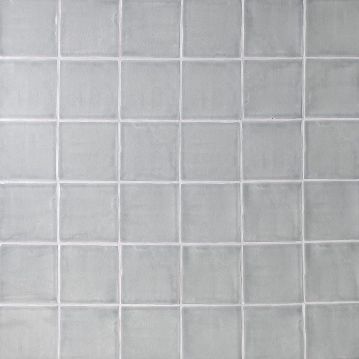 Wall of square grey handmade wall tiles finished with White grout, ideal for a bathroom or kitchen