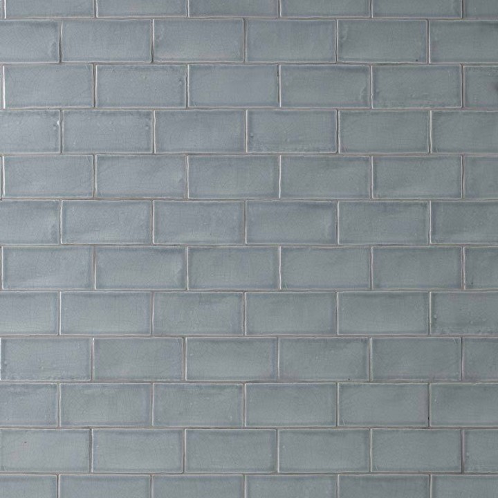 Wall of metro medium grey handmade wall tiles finished with medium grout laid in a brick bond tile pattern