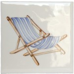 A cut out of an antique white square tile with deck chair illustration
