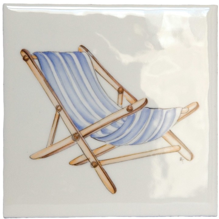A cut out of an antique white square tile with deck chair illustration