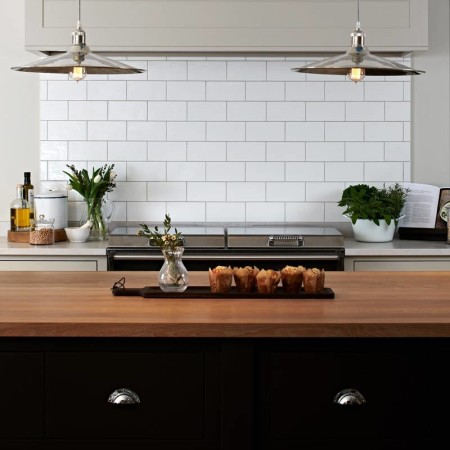 Neptune kitchen with our Alabaster chalk white large metro brick tiles as a cooker panel