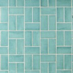 Wall of aqua green medium brick metro tiles with beige grout