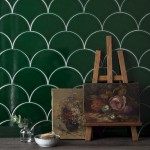 Wall of emerald green scallop tiles behind an easel with fine art painting