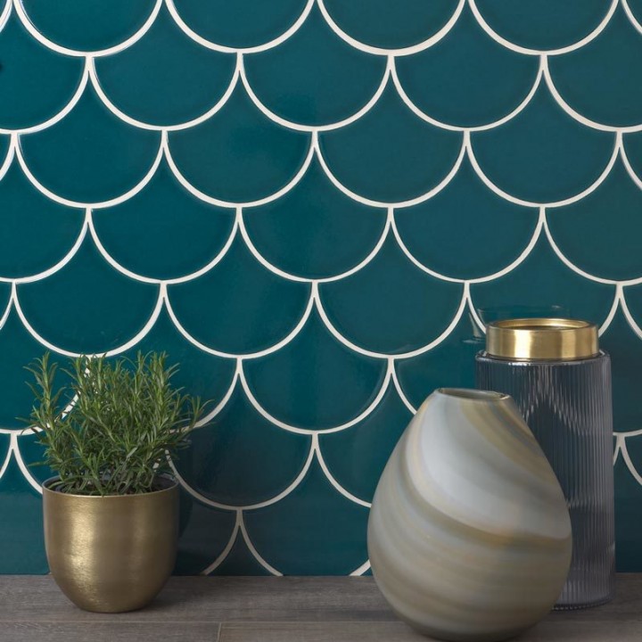 Wall of sapphire navy scallop tiles with white grout against an oak work top behind home accessories