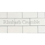 Cut out of Three word metro tiles with the words 'Rhubarb Crumble' hand painted on them