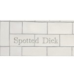 Cut out of two word metro tiles with the word 'Spotted Dick' hand painted on them