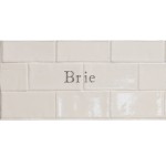 Cut out of two word metro tiles with the word 'Brie' hand painted on them