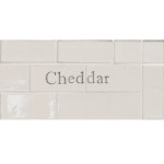 Cut out of two word metro tiles with the word 'Cheddar' hand painted on them