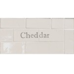 Cut out of two word metro tiles with the word 'Cheddar' hand painted on them