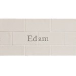 Cut out of two word metro tiles with the word 'Edam' hand painted on them