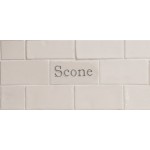 Cut out of one word metro tiles with the word 'scone' handpainted on them