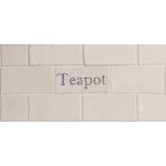 Cut out of one word metro tile with the word 'teapot' hand painted on them