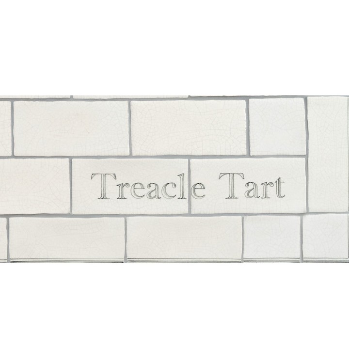 Cut out of two word metro tiles with the word 'Treacle Tart' hand painted on them