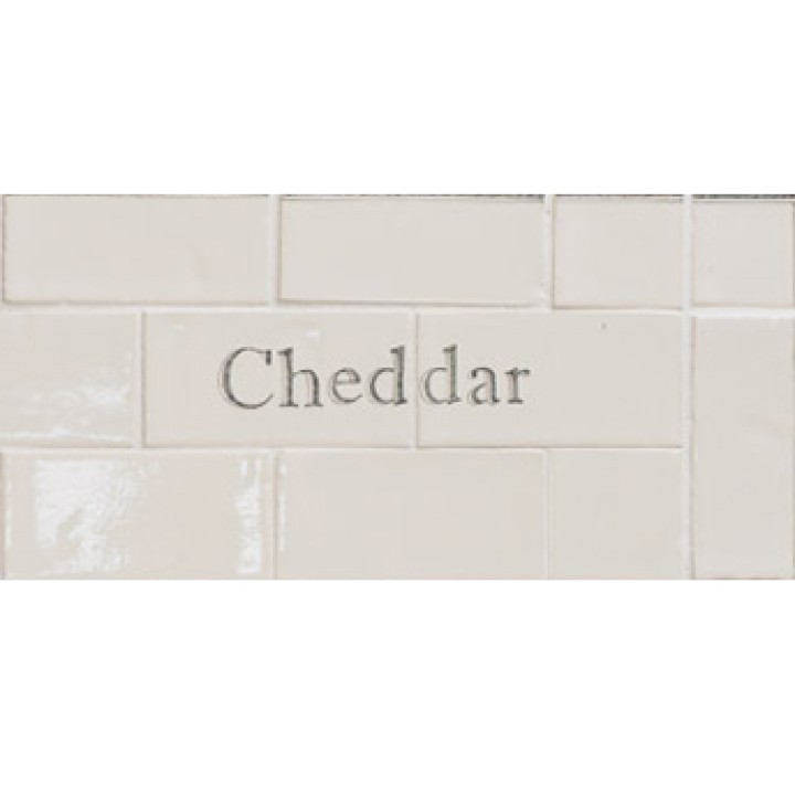 Cut out of two word metro tiles with the word 'Cheddar' hand painted on them