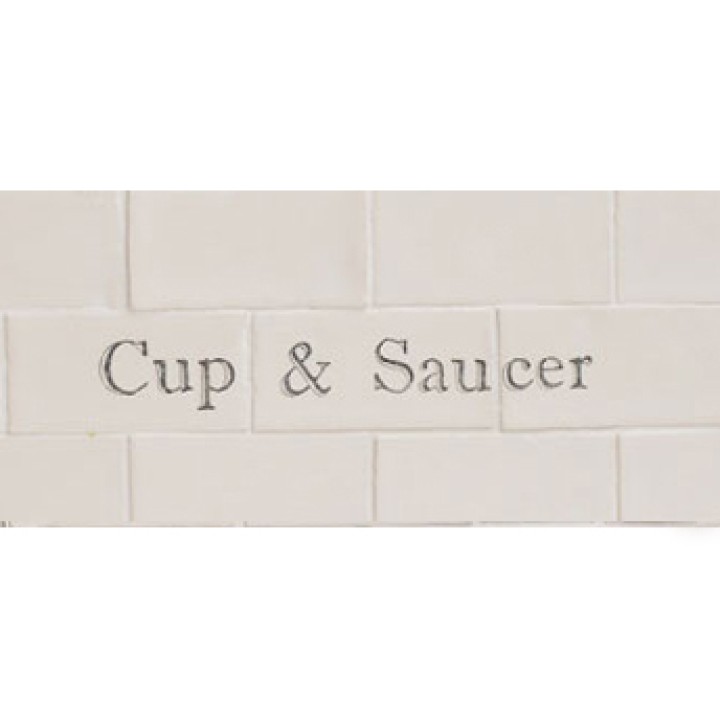 Cut out of three word metro tiles with the word 'cup & saucer' hand painted on them