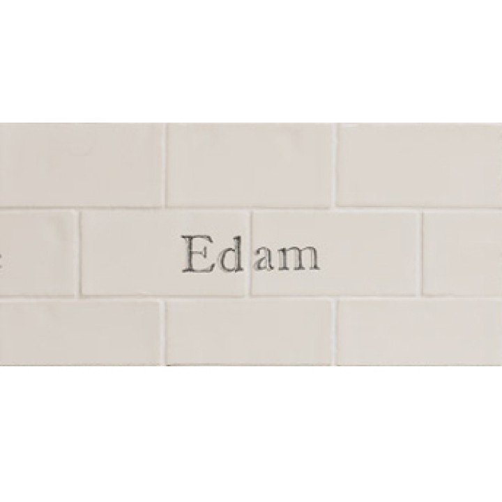 Cut out of two word metro tiles with the word 'Edam' hand painted on them