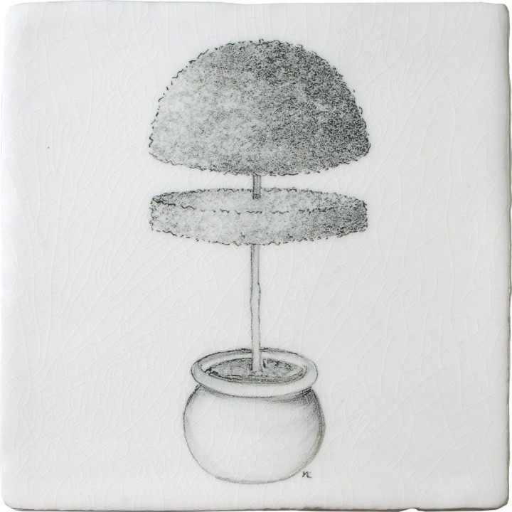 A cut out of an antique white square tile with topiary illustration in a charcoal style