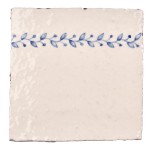 Cut out image of white tile with handpainted delft blue order ornate pattern