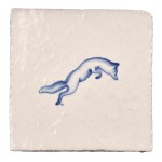 Cut out image of white tile with handpainted delft blue fox illustration