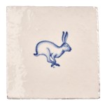 Cut out image of white tile with handpainted delft blue hare illustration