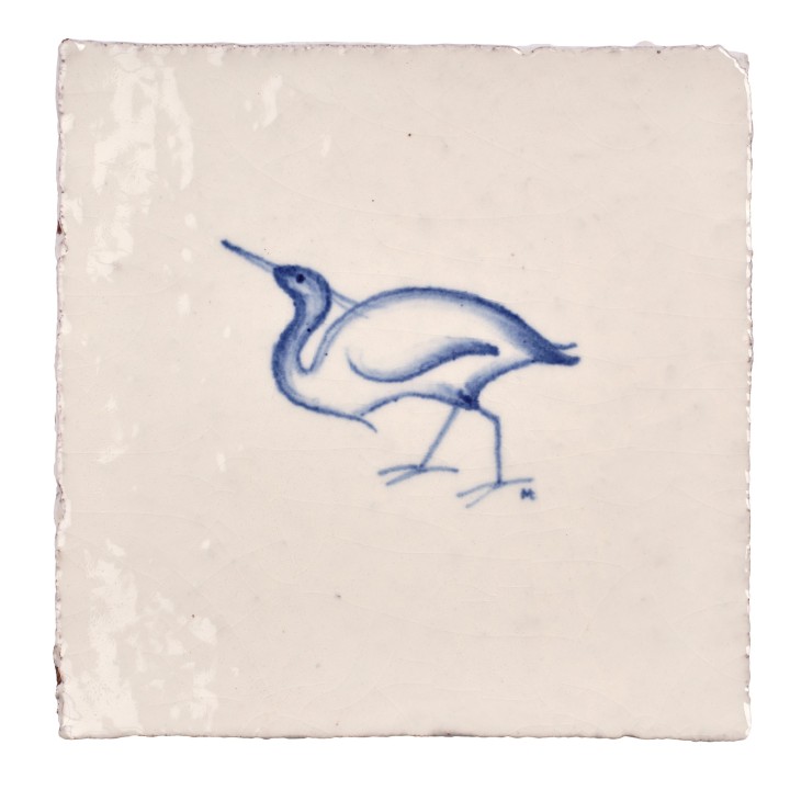 Cut out image of white tile with handpainted delft blue egret illustration